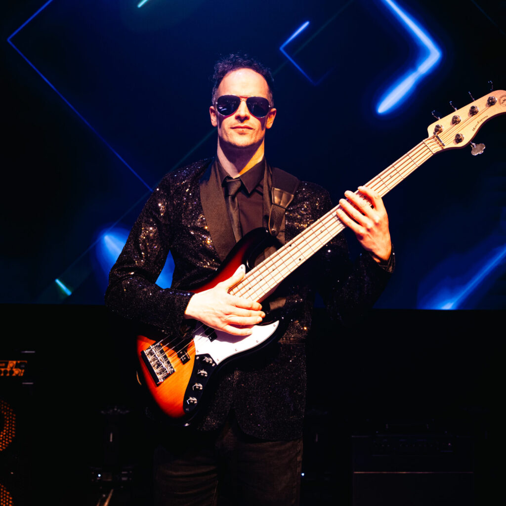 michael whent bass player in daft punkz against colour backdrop